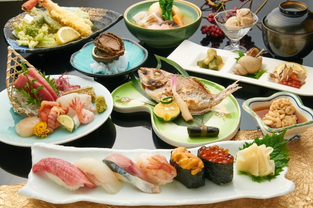 various traditional japanese dishes including sushi, fish, sashimi and soup